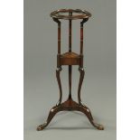 A George III mahogany stand, with circular top, turned supports,