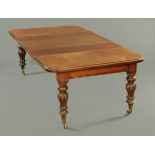 A Victorian mahogany wind out dining table, with one leaf, with rounded corners, recessed frieze,