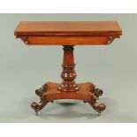 An early Victorian mahogany turnover top tea table, with stylised tulip carved column,