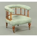 A Victorian walnut tub chair, turned spindled supports,