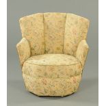 A tub chair, with angled back and arms, with octagonal seat and raised on short bun feet,