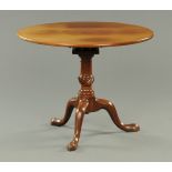 A George III mahogany tripod table, with bird cage support and raised on three downswept legs.