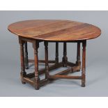 A Georgian oak gate legged dining table, oval,