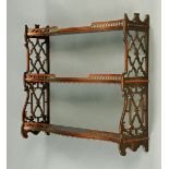 A wall hanging shelf unit, in the Chippendale style, with fretwork sides.  Width 79 cm. CONDITION