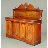 A Victorian mahogany inverted breakfront sideboard, with rear upstand with scrolling mouldings.