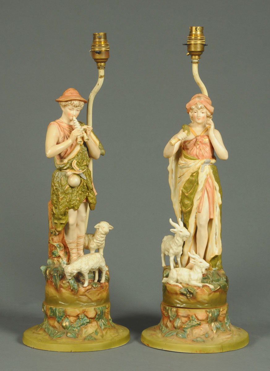 A pair of Continental porcelain table lamps, in the Royal Dux style,