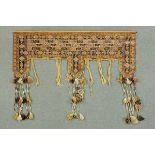 * An Afghan tent door surround, beige and brown, with tassels and metal pole.  Width 175 cm.