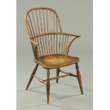 A 19th century Windsor armchair, with spindled back, shaped seat and raised on turned legs.