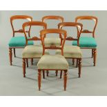 A set of six Victorian mahogany dining chairs, with bowed top rails, shaped stiles,