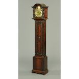 An oak three-train Grandmother clock, with silvered brass dial,