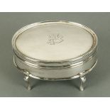 An oval silver bijouterie box, London 1914, plush lined interior.  Width 11.2 cm.