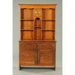 An Arts & Crafts oak Welsh dresser, with moulded cornice,