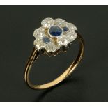 A Sapphire and diamond cluster ring, rubover set, circa 1930, yellow gold coloured metal shank,