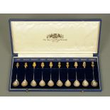 The American Royal Family, ten parcel gilt silver spoons, each with sovereign terminal,