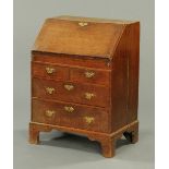 A Queen Anne oak bureau, the slope front opening to a fitted interior with well and with drawers