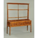 A George III oak dresser with Delft rack,