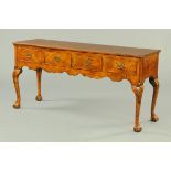 An oak dresser base, in the Queen Anne style, with well figured top and frieze,