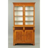 A Victorian oak and mahogany bookcase on cupboard,