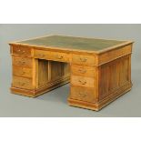 A late 19th/early 20th century oak partners desk, with green tooled leather writing surface,