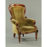 A Victorian mahogany framed gentleman's armchair, with deep buttoned back,