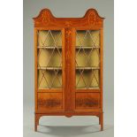 An Edwardian inlaid mahogany display case, with double arched top,