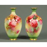 A pair of Royal Worcester vases, handpainted with roses, each signed "C.V. White", green printed