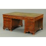 A mahogany pedestal desk, circa 1925, with green tooled leather writing surface,