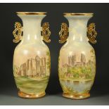 A large pair of 19th century handpainted vases, decorated with castles in landscape.  Height 66 cm.