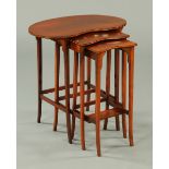 An Edwardian nest of three kidney shaped tables, raised on tapered legs of square section.