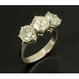 A large 18 ct white gold three stone diamond ring, diamond weight 3.