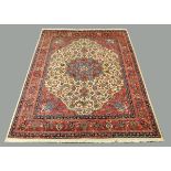 A Persian design woollen carpet, with centre floral medallion, with repeating line border and