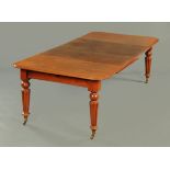 A Victorian mahogany dining table, with wind out action, rounded corners,