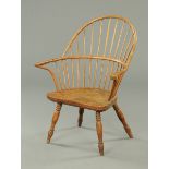 An early 19th century Windsor armchair, with broad spindled back,