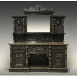 A late Victorian carved oak mirror back sideboard, the superstructure carved with lion masks,