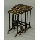 A nest of three lacquered tables, with turned legs and shaped supports.  Width 49 cm.