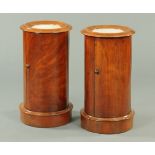 A pair of Victorian mahogany cylinder pot cupboards, with marble tops and plinth bases.