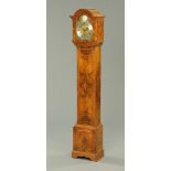 A walnut grandmother clock, three-train with silvered brass dial, with Elliott movement striking