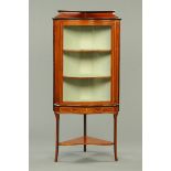 An Edwardian inlaid mahogany serpentine fronted corner cupboard, standing, with glazed door,