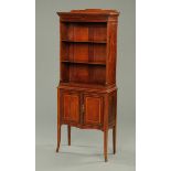 An Edwardian inlaid mahogany open bookcase on cupboard,