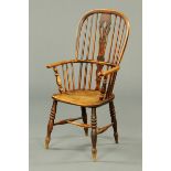 A 19th century Windsor armchair, with pierced splat back, shaped seat and raised on turned legs.