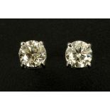 A pair of 18 ct white gold screw back stud earrings, set with diamonds weighing 1.