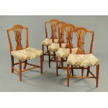 A set of five George III mahogany Hepplewhite style dining chairs, with pierced splat backs,
