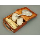 A George V gentleman's silver mounted brush set, Birmingham 1913, leather cased,