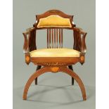 An Edwardian inlaid mahogany armchair, with rollover back,