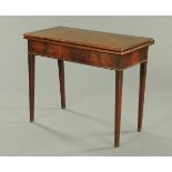 A George III mahogany turnover top tea table, raised on tapered legs of square section.  Width 91.