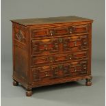 A late 17th century oak chest of drawers, with moulded edge above four long drawers with cushioned