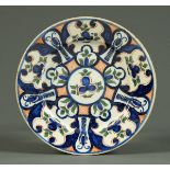 An 18th century English Delft plate, decorated in blue, greens and red.  Diameter 29 cm (see