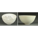 * A plain white porcelain tea bowl, unmarked, diameter 9 cm, and a reticulated bowl,