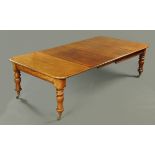 A Victorian mahogany wind out dining table, with two leaves, with moulded edge, rounded corners,