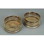 A pair of Regency old Sheffield plate bottle coasters.  Diameter 12.5 cm.